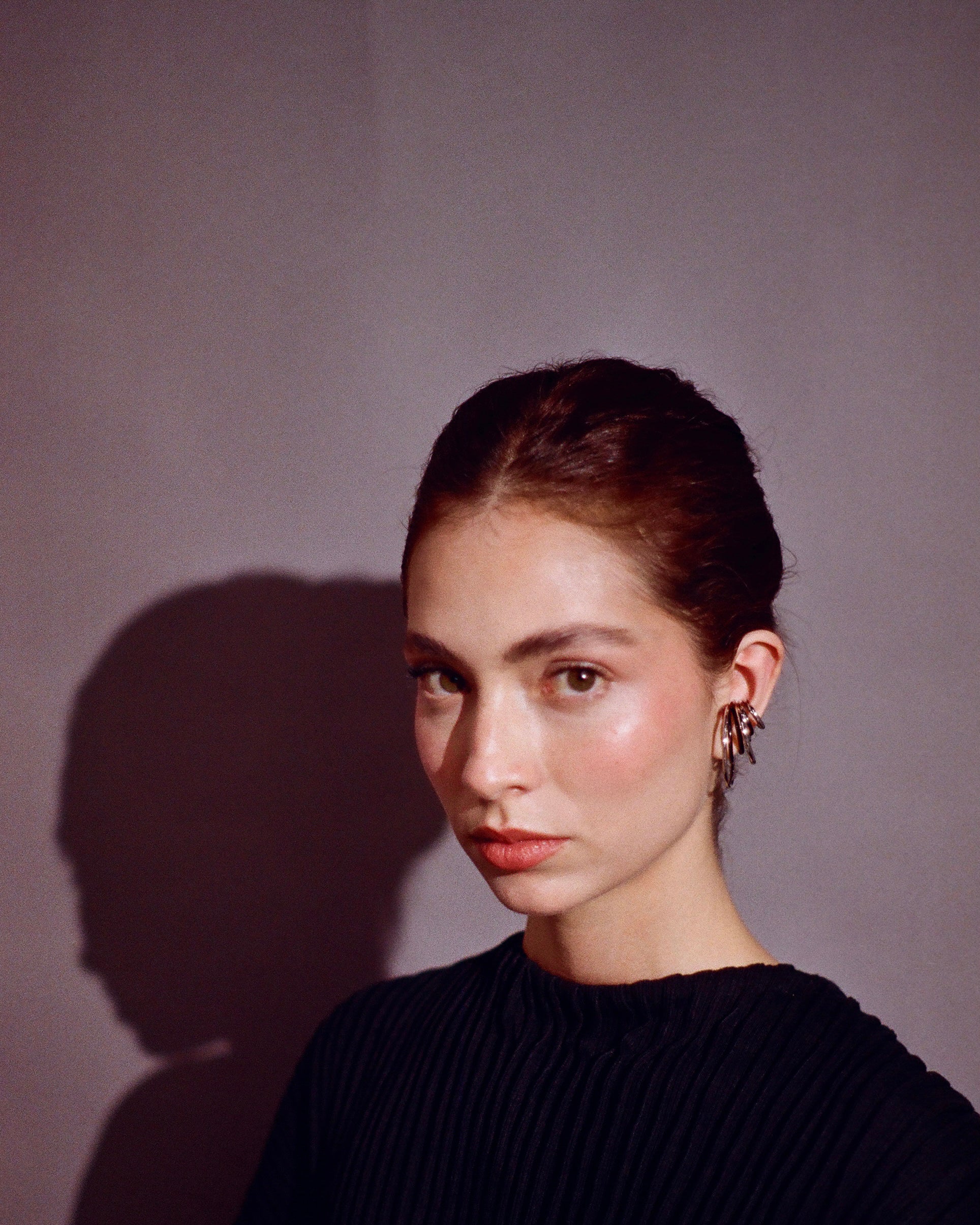 woman using many ear cuffs in ear