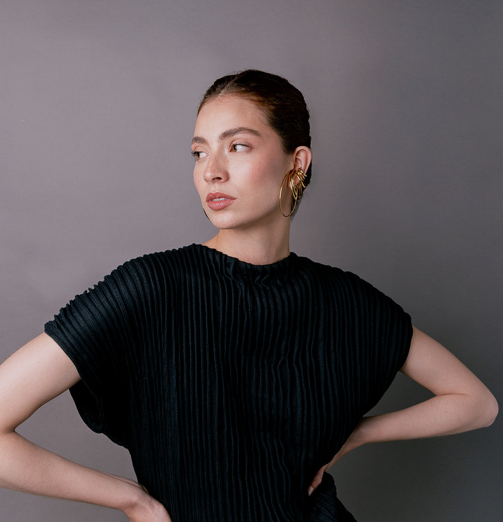 woman wearing a lot of ear cuffs
