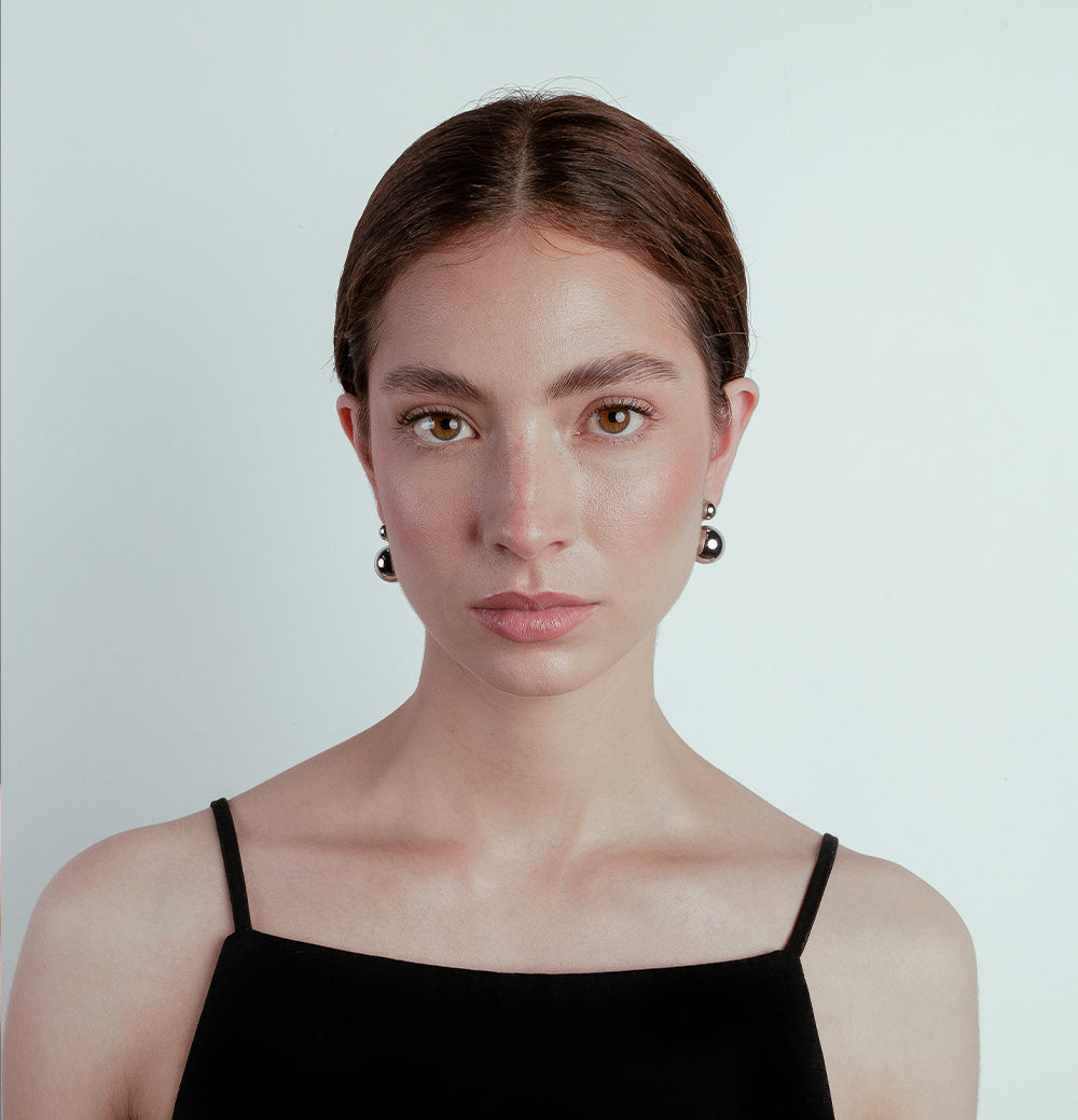 woman with double ball earrings